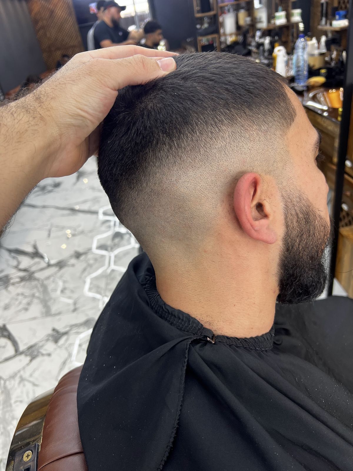 Mid fade met volle baard, van achteren gezien